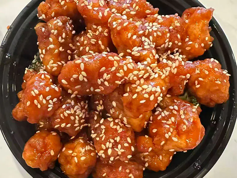 Crispy chicken bites coated in sesame sweet-sour sauce at Ming Garden, a Chinese Restaurant in Huntersville